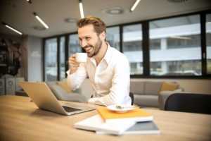 Student studeert voorbereiding op gitp assessment met leerboeken en laptop