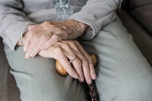 Home Geriatrie fysiotherapie behandeling: oudere patiënt voert oefening uit onder begeleiding van fysiotherapeut in praktijk Geuls