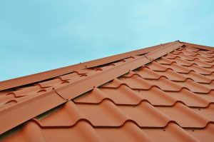 Dakspecialist voert inspectie uit om daklekkage op te sporen en reparatie te bepalen